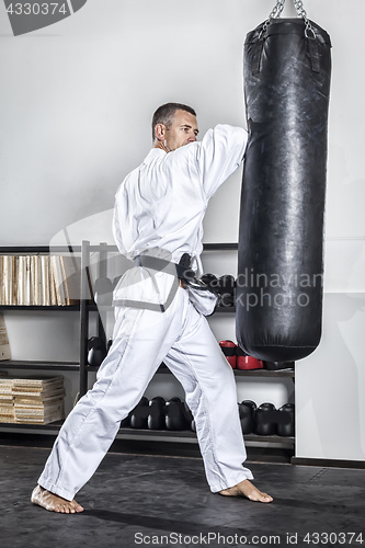 Image of a middle age man at the punch bag
