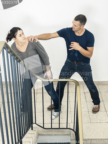 Image of young woman fighting with man