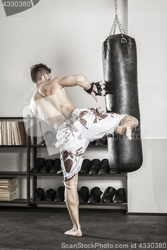Image of a young man at the punch bag