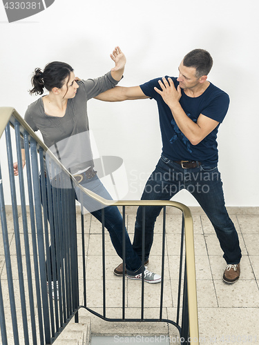 Image of young woman fighting with man