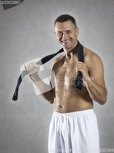 Image of middle age martial arts sports man with a black belt