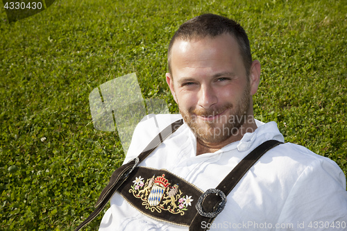 Image of bavarian tradition man in the grass