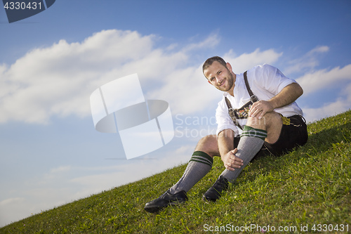 Image of bavarian tradition man in the grass