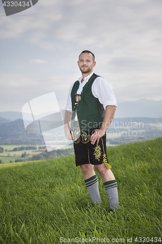 Image of bavarian tradition man in the grass