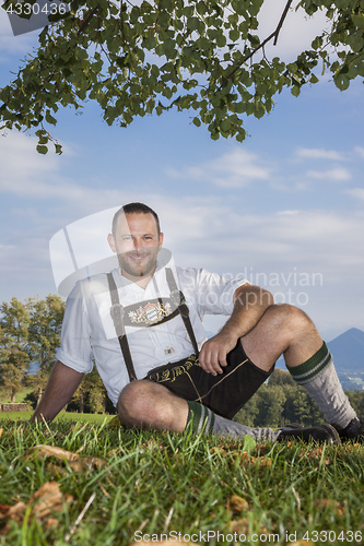 Image of bavarian tradition man in the grass