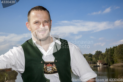 Image of bavarian tradition man at the lake