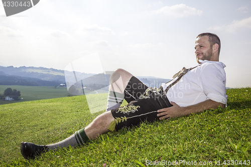 Image of bavarian tradition man in the grass