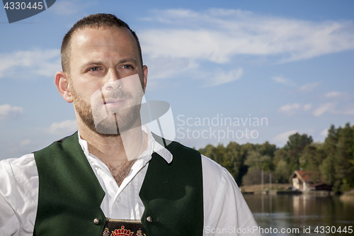 Image of bavarian tradition man at the lake