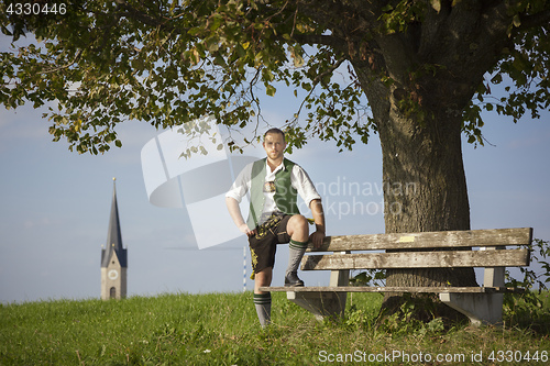 Image of bavarian tradition man in the grass
