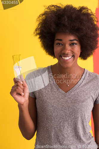 Image of black woman painting wall