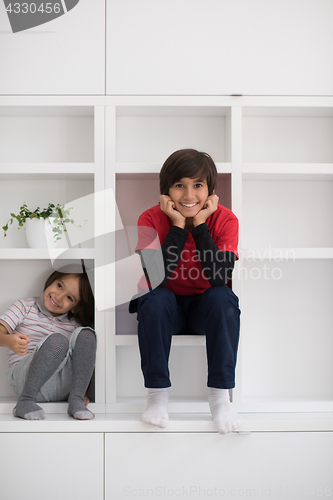 Image of young boys posing on a shelf