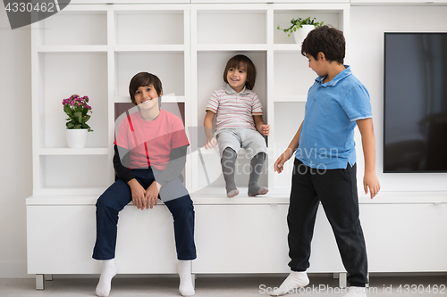 Image of young boys posing on a shelf