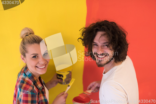 Image of couple painting interior wall