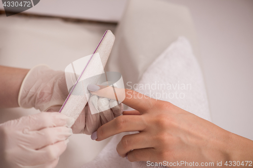 Image of Woman hands receiving a manicure