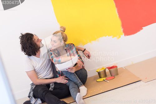 Image of Happy young couple relaxing after painting