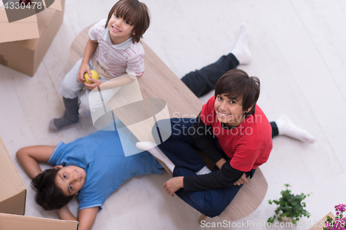 Image of boys with cardboard boxes around them top view