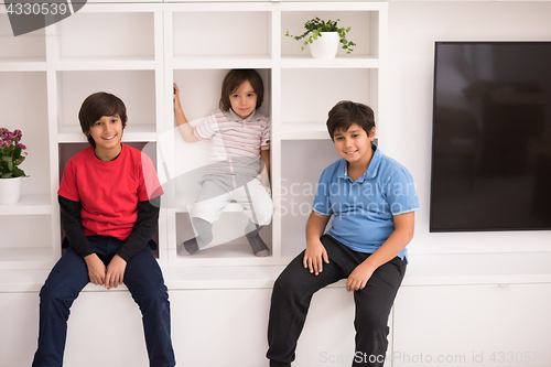 Image of young boys posing on a shelf