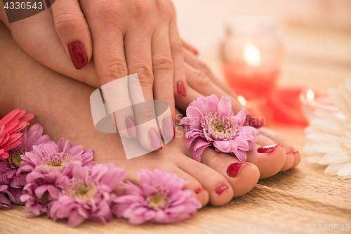 Image of female feet and hands at spa salon