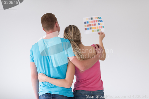 Image of couple looking at color samples at home