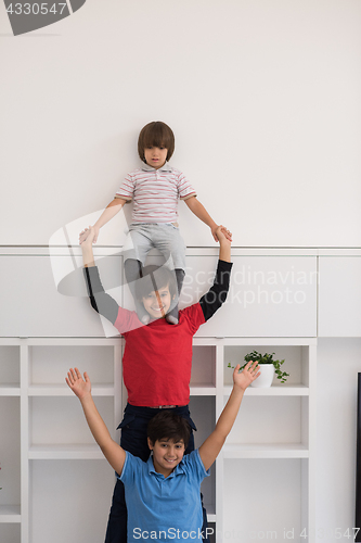 Image of young boys posing line up piggyback
