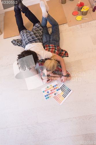 Image of Happy young couple relaxing after painting