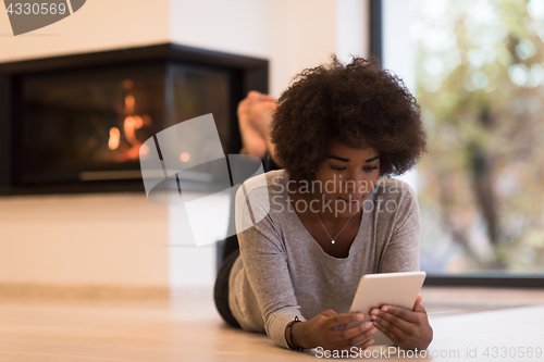 Image of black women using tablet computer on the floor