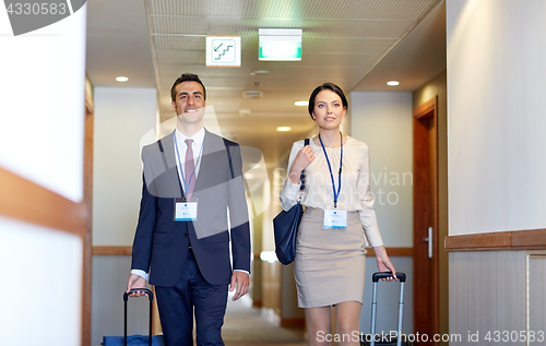 Image of business team with travel bags at hotel corridor