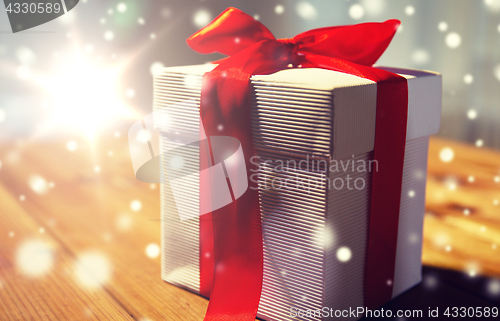 Image of close up of christmas gift box on wooden table