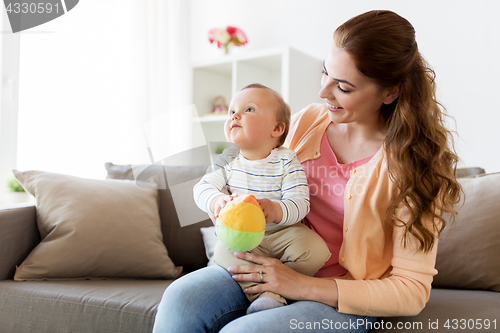 Image of happy young mother with little baby at home