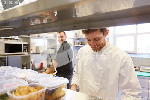 Image of chef and cook cooking food at restaurant kitchen