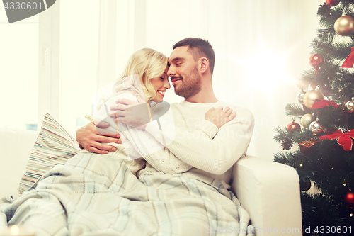 Image of happy couple at home with christmas tree