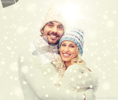 Image of smiling couple in winter clothes hugging