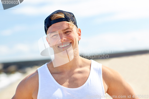 Image of smiling young man on summer beach
