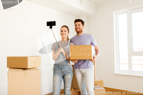 Image of happy couple with boxes moving to new home