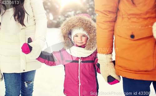 Image of happy family with child in winter clothes outdoors