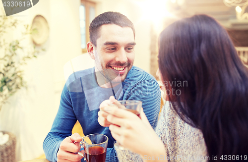 Image of happy couple drinking tea at cafe