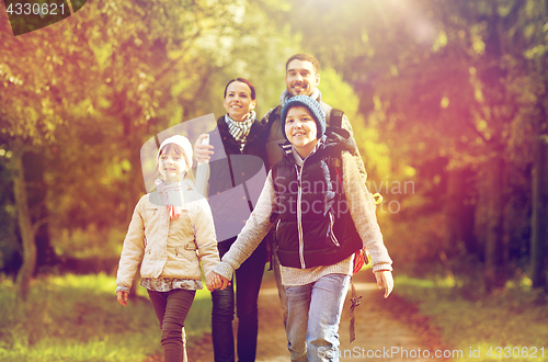 Image of happy family with backpacks hiking