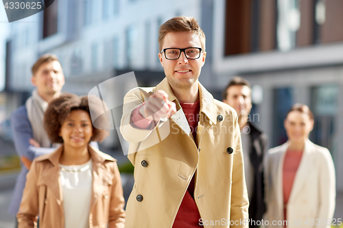 Image of businessman pointing finger over people on street
