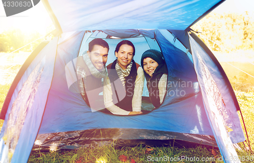 Image of happy family in tent at camp site