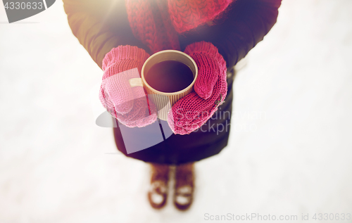 Image of close up of woman with tea mug outdoors in winter