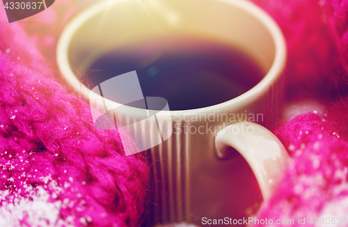 Image of close up of tea or coffee and winter scarf in snow