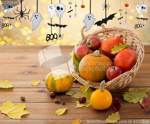 Image of pumpkins in basket and halloween party garland