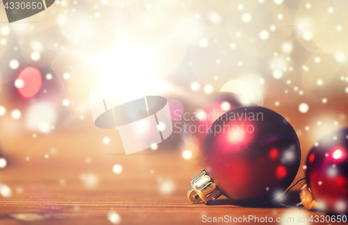 Image of close up of red christmas balls on wood