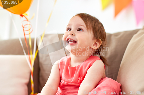 Image of happy baby girl on birthday party at home