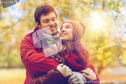 Image of happy young couple hugging in autumn park
