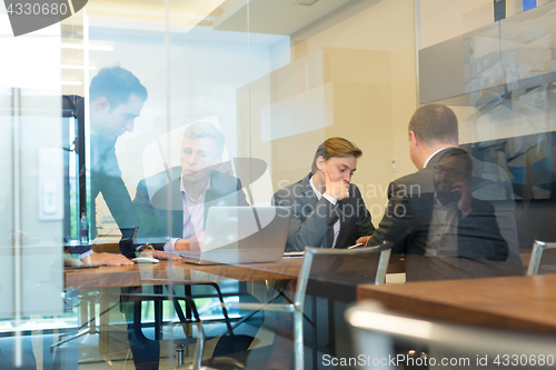 Image of Business people sitting and brainstorming at corporate meeting.