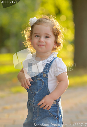 Image of Happy little girl in autumn park