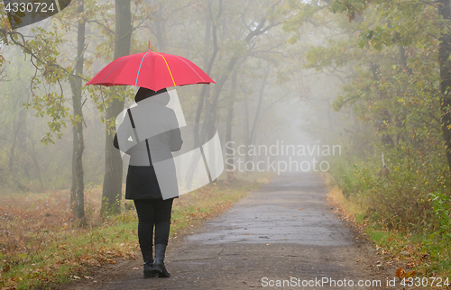 Image of Depressed woman with red umbrella