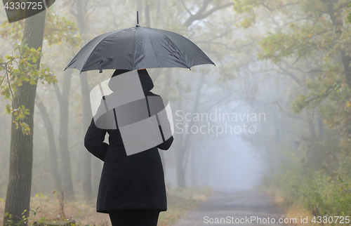 Image of Depressed woman with red umbrella