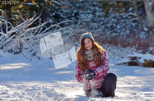 Image of teen girl playing in snow